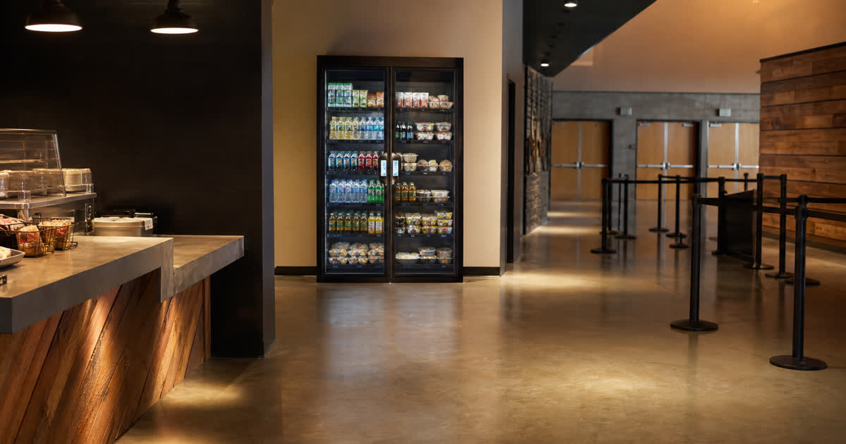 Revvolto smart vending cooler in an event venue lobby near a concession pause path