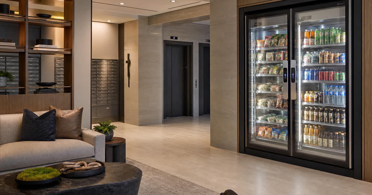 Revvolto smart vending cooler in an apartment resident lounge near the daily path