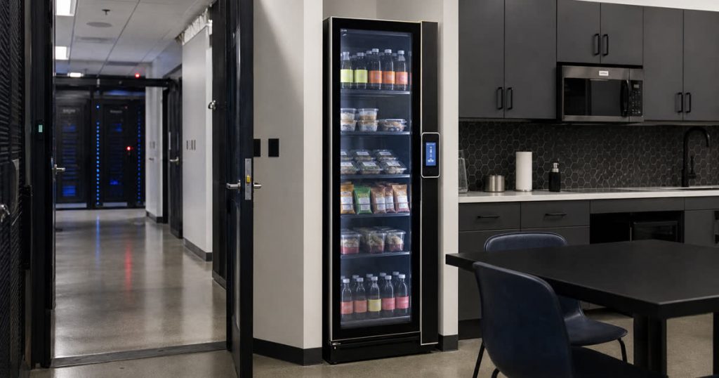 Revvolto smart vending cooler in a secure facility staff break area near a data center corridor
