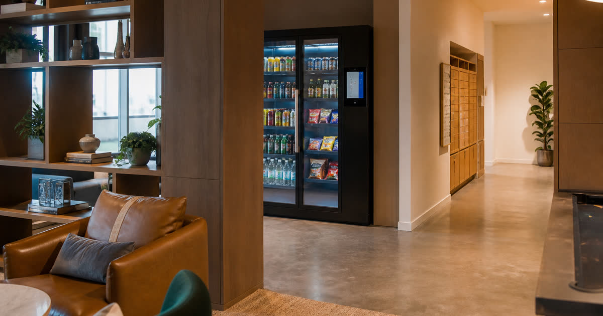 Revvolto smart vending cooler in an Austin apartment amenity path with stocked clear glass and cashless access