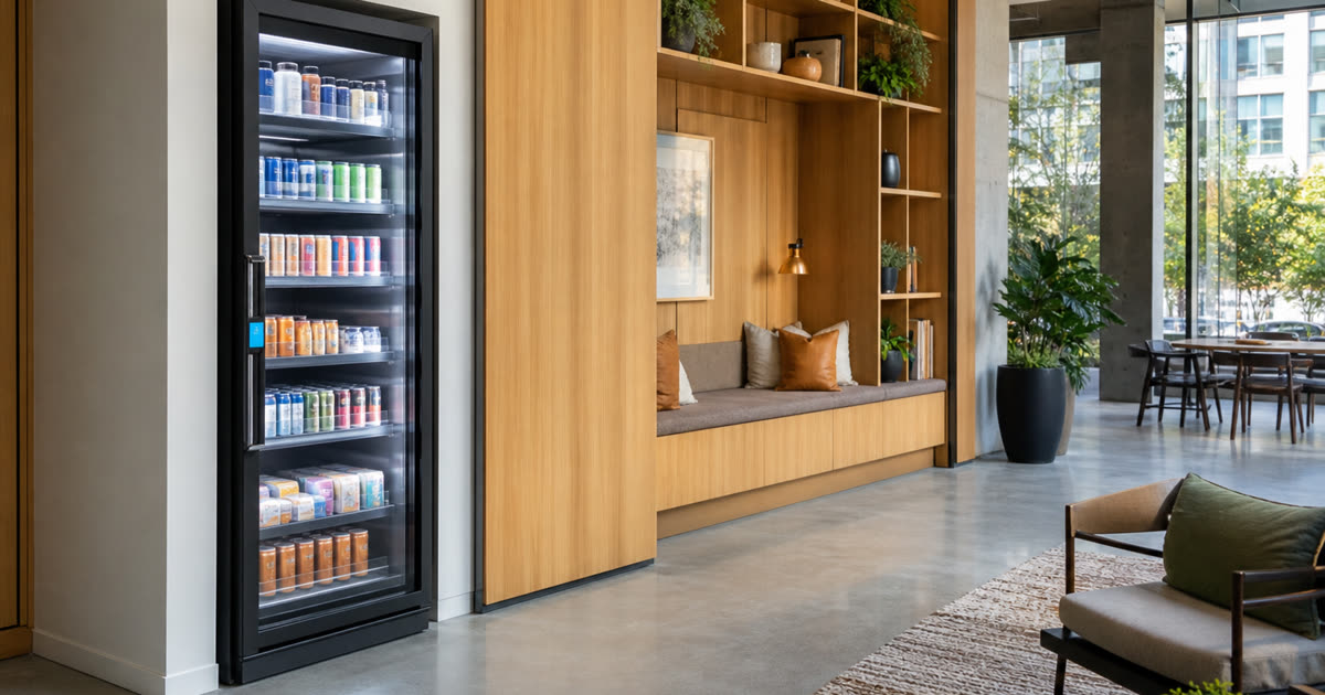 Revvolto smart fridge in an Austin mixed-use amenity lounge with clear glass stocked shelves