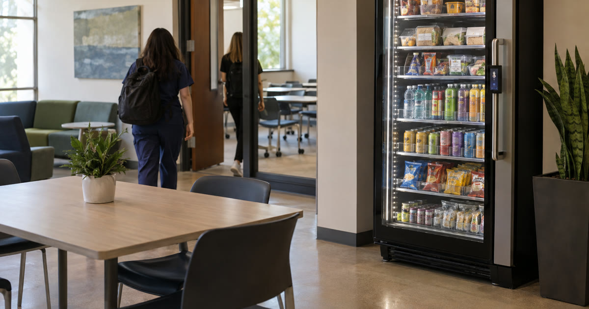 Revvolto smart vending cooler in an Austin campus training lounge with stocked glass shelves