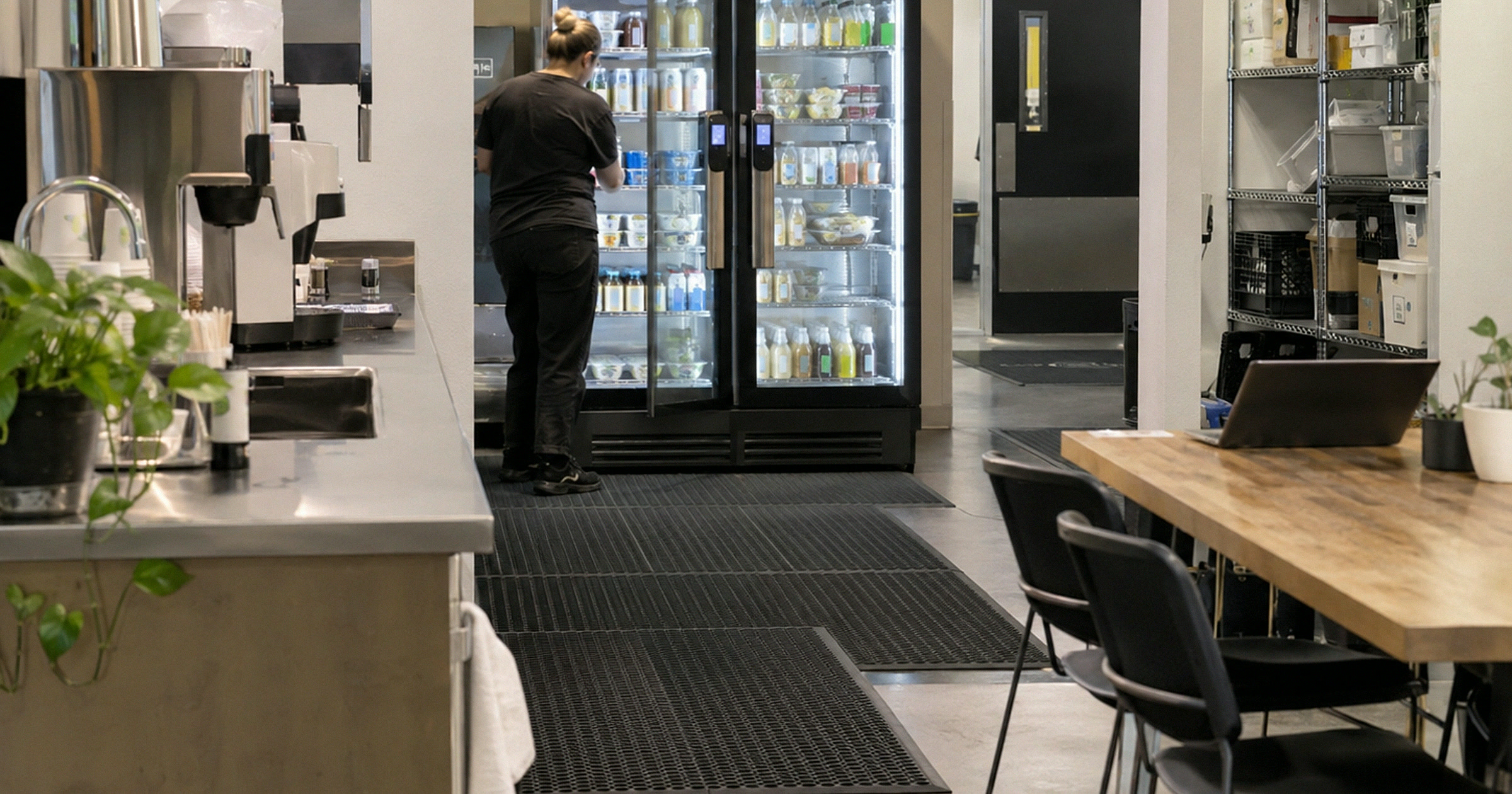 Revvolto smart vending cooler being restocked in a coworking service kitchen area